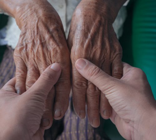 young-woman-holding-elderly-woman-s-hand_1150-12496